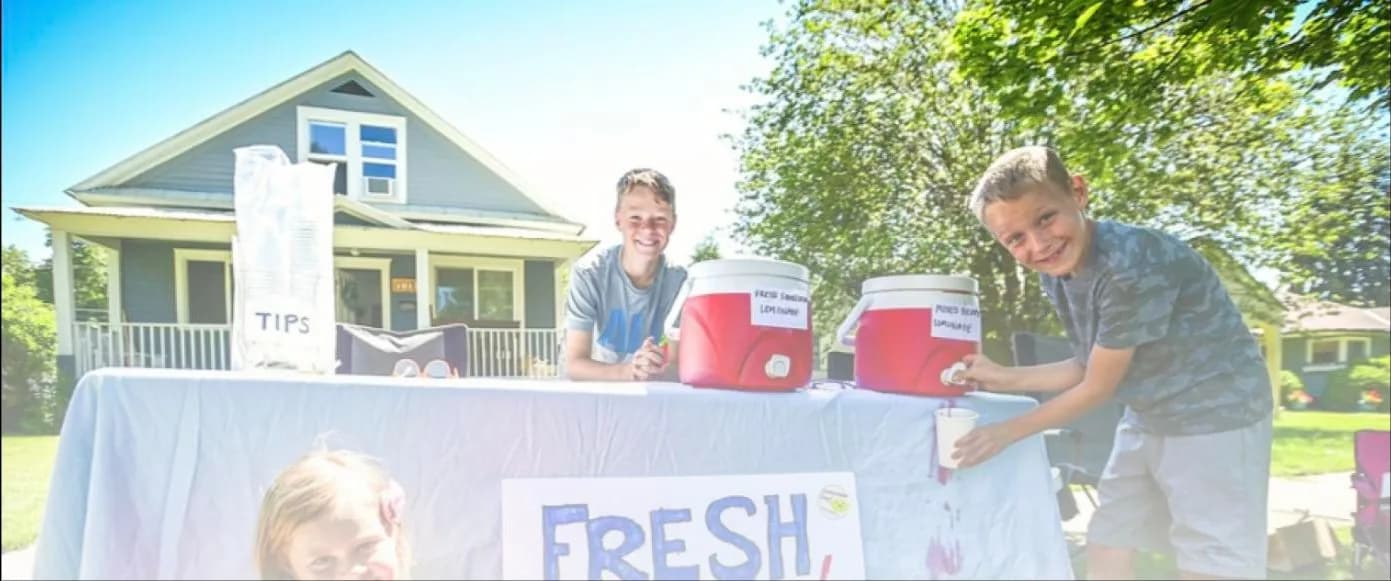Kids selling lemonade on a sunny day