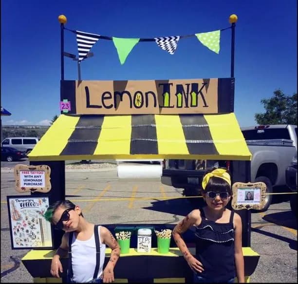 Kids running a bright yellow lemonade stand