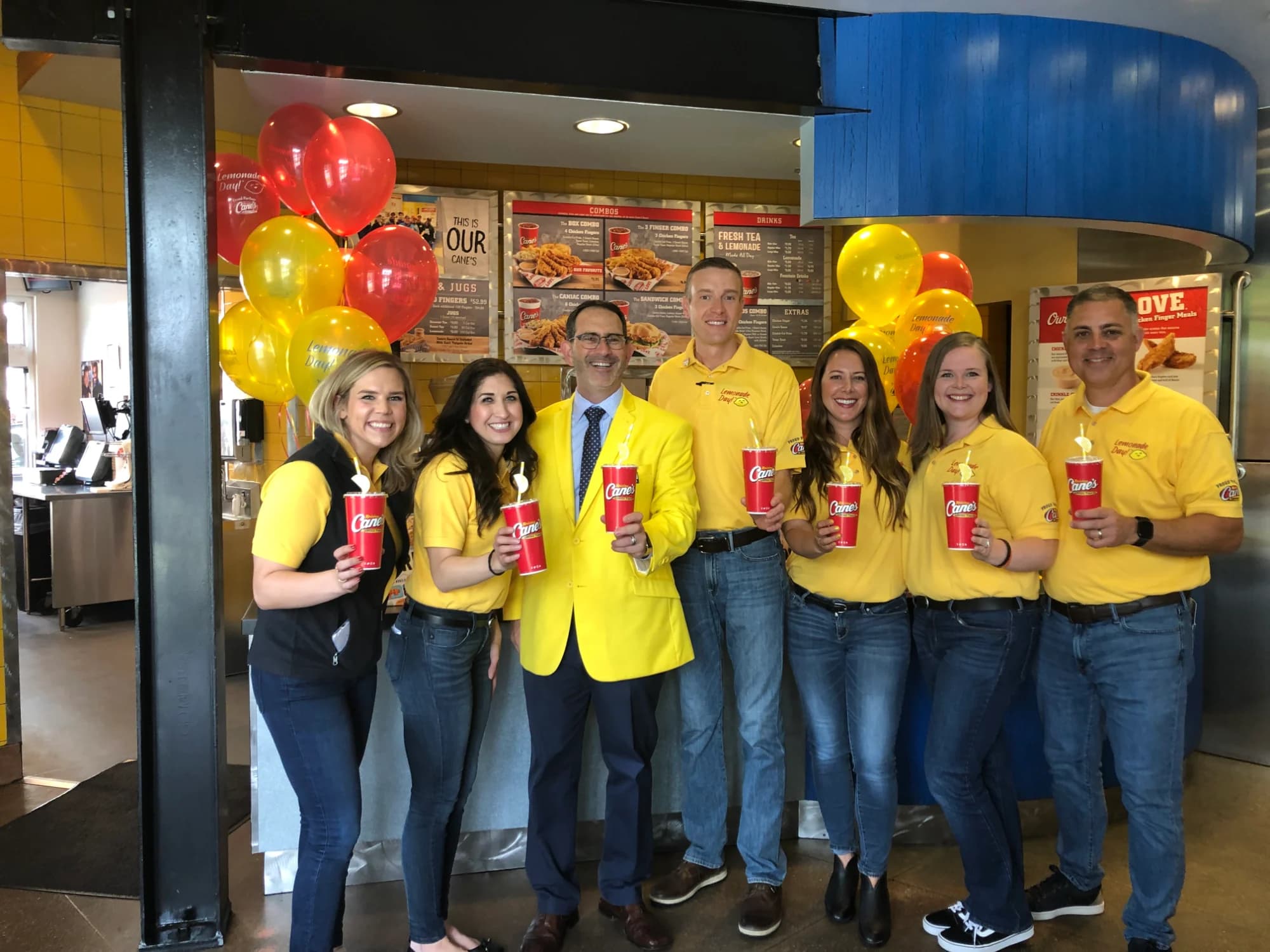 Raising Cane's team with balloons at a Lemonade Day event