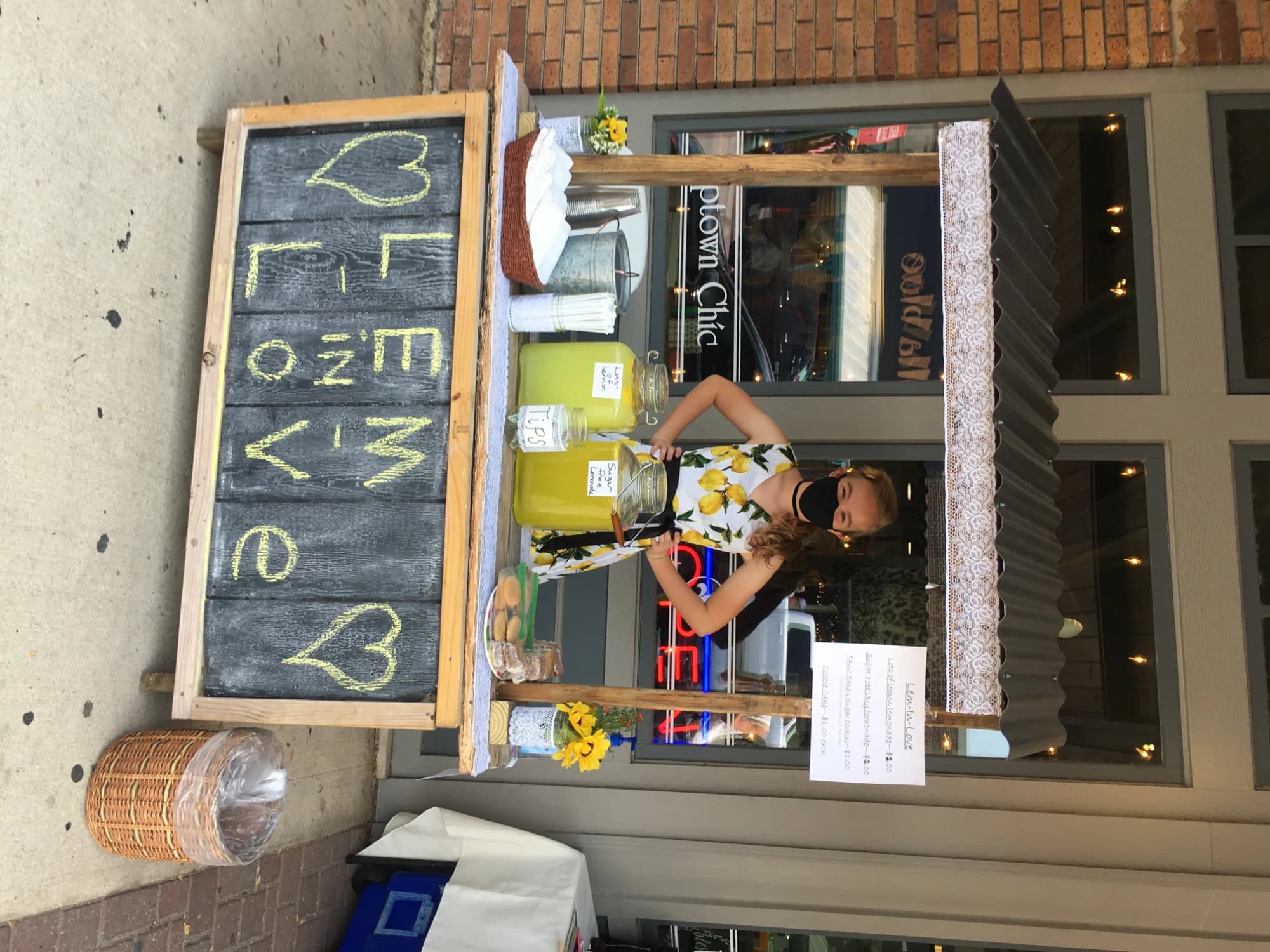 A hand-lettered Lem-Love chalkboard sign at a stand